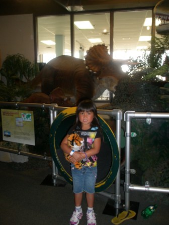 Kasen posing with dinosaurs at Science Center